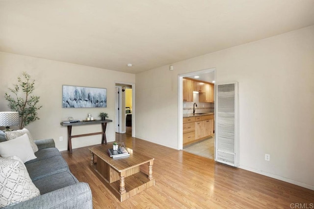 5566 Streamview Dr, San Diego, CA 92105 - living area featuring light wood-style floors, a heating unit, and baseboards