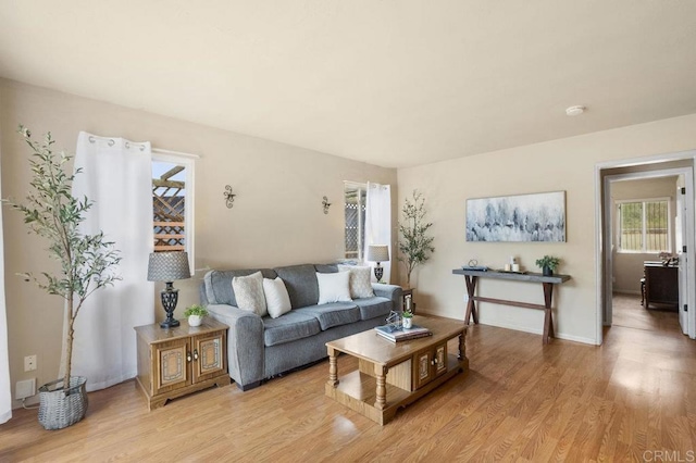 5566 Streamview Dr, San Diego, CA 92105 - living room featuring baseboards, a wealth of natural light, and light wood-type flooring