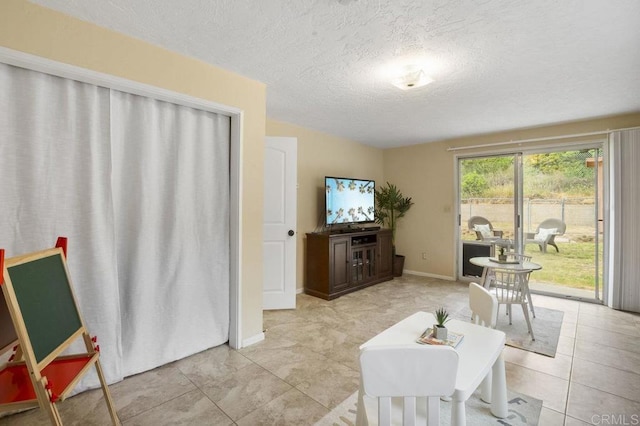 5566 Streamview Dr, San Diego, CA 92105 - living room with light tile patterned floors, baseboards, and a textured ceiling