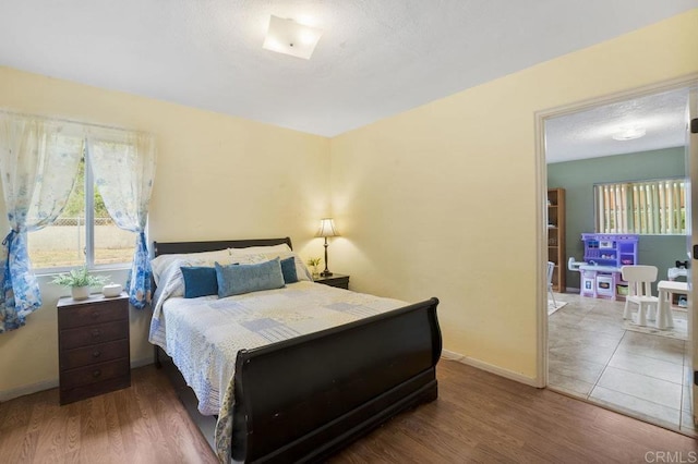5566 Streamview Dr, San Diego, CA 92105 - bedroom with baseboards and wood finished floors