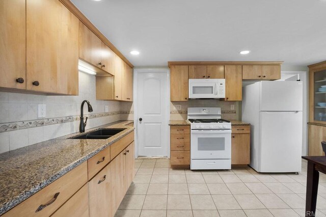 5566 Streamview Dr, San Diego, CA 92105 - kitchen with decorative backsplash, a sink, stone counters, white appliances, and light tile patterned flooring