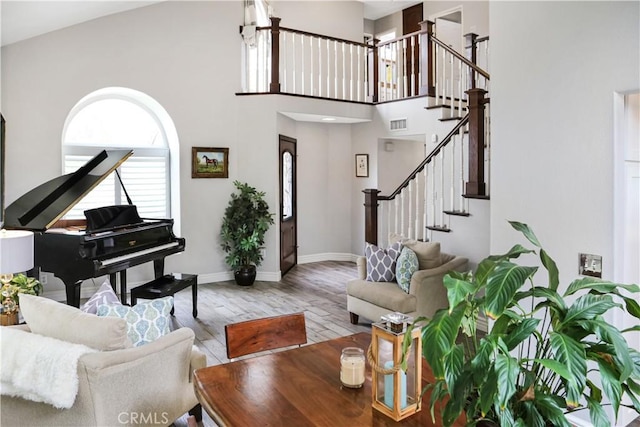 11818 Mount Harvard Ct, Rancho Cucamonga, CA 91737 - living area with wood finished floors, stairs, baseboards, and a high ceiling