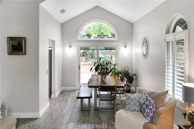 11818 Mount Harvard Ct, Rancho Cucamonga, CA 91737 - dining area featuring wood finished floors, vaulted ceiling, and baseboards