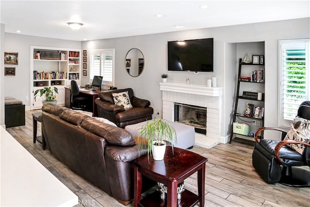 11818 Mount Harvard Ct, Rancho Cucamonga, CA 91737 - living area with light wood finished floors and a brick fireplace