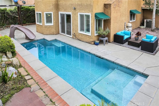 11818 Mount Harvard Ct, Rancho Cucamonga, CA 91737 - view of pool featuring a water slide, central air condition unit, a patio, and an outdoor living space