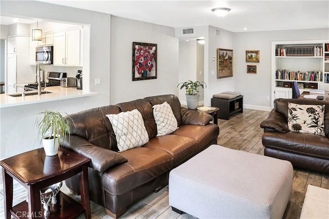 11818 Mount Harvard Ct, Rancho Cucamonga, CA 91737 - living room with light wood-style flooring and baseboards