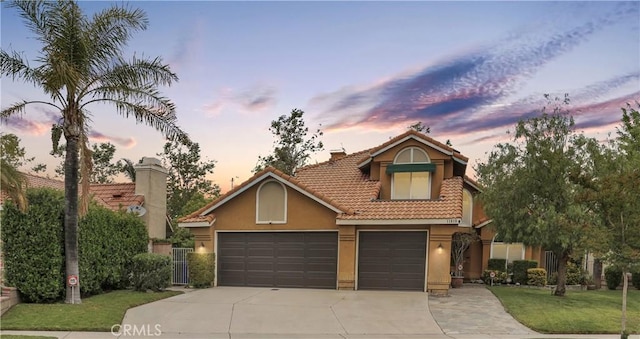 11818 Mount Harvard Ct, Rancho Cucamonga, CA 91737 - view of front facade with concrete driveway, stucco siding, a tile roof, a front lawn, and a chimney