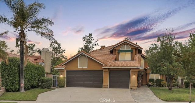 11818 Mount Harvard Ct, Rancho Cucamonga, CA 91737 - view of front facade featuring concrete driveway, stucco siding, a tiled roof, a yard, and a chimney