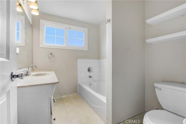 bathroom featuring vanity, a bath, and toilet
