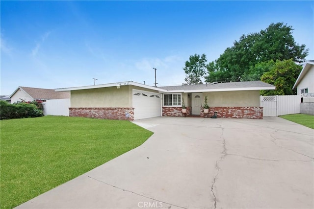 view of front of house with fence, an attached garage, brick siding, a front yard, and concrete driveway