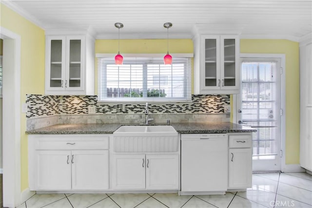 kitchen with white dishwasher, crown molding, and a sink