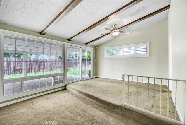 unfurnished sunroom featuring beam ceiling
