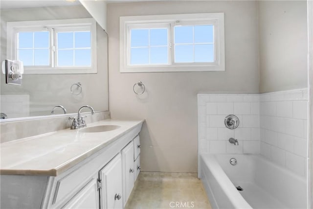 bathroom featuring vanity, tile patterned flooring, a garden tub, and a healthy amount of sunlight