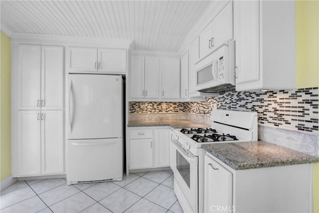 kitchen with light tile patterned floors, white appliances, and white cabinetry