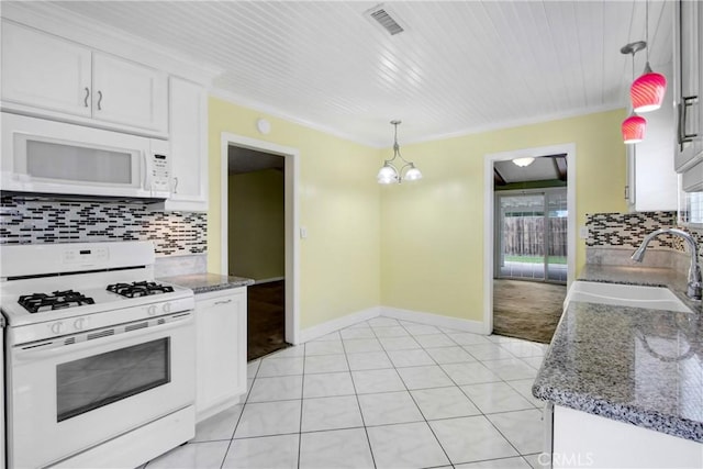 kitchen featuring a sink, decorative backsplash, white cabinets, and white appliances