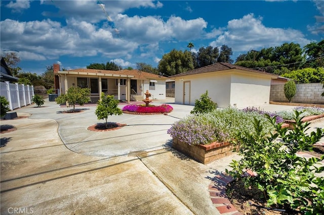 exterior space with stucco siding and fence