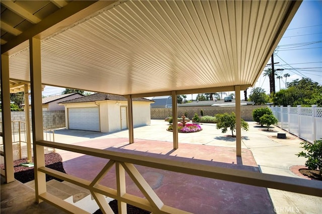 view of patio with fence private yard and an outbuilding