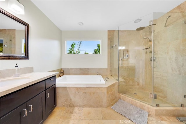 full bath with tile patterned floors, a shower stall, a garden tub, and vanity