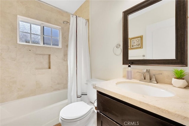 bathroom with toilet, shower / tub combo with curtain, and vanity