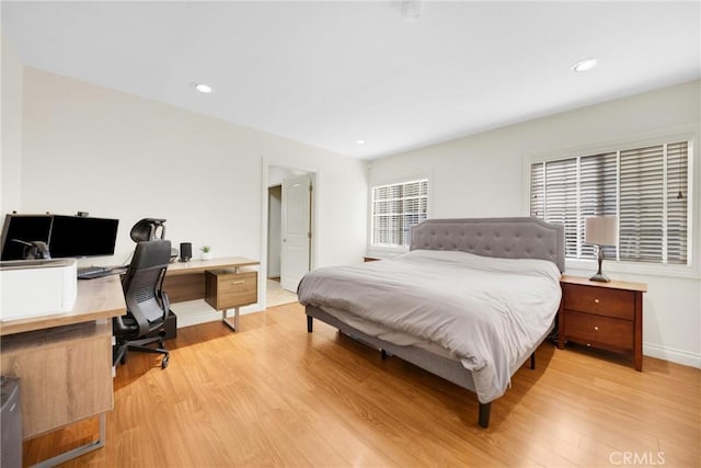 bedroom featuring baseboards, recessed lighting, and light wood finished floors