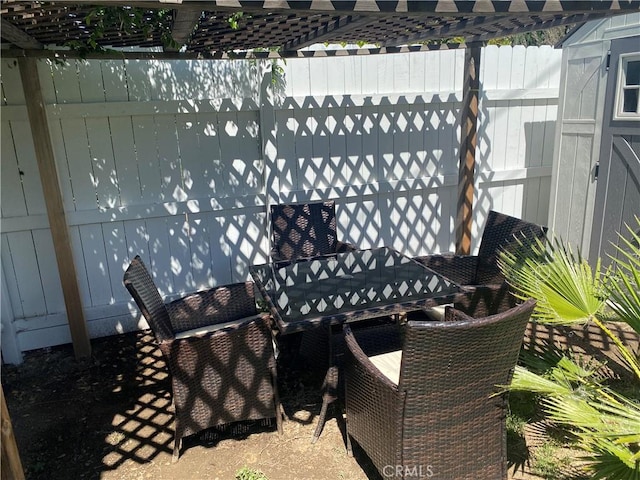 view of patio / terrace featuring fence and outdoor dining space