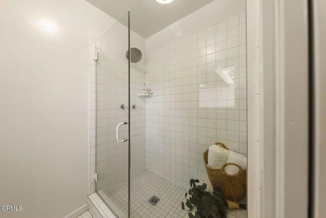 bathroom with tile patterned floors and a shower stall