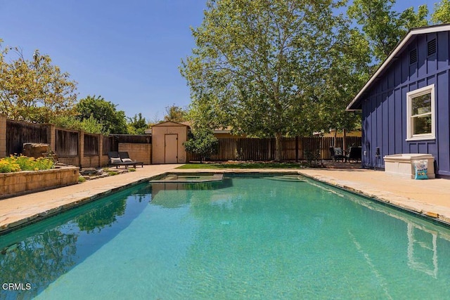 view of swimming pool with a pool with connected hot tub, a shed, a fenced backyard, a patio area, and an outdoor structure