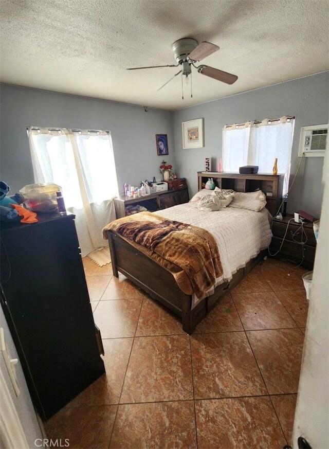 2043 City View Ave, Los Angeles, CA 90033 - tiled bedroom with multiple windows, a textured ceiling, a ceiling fan, and an AC wall unit