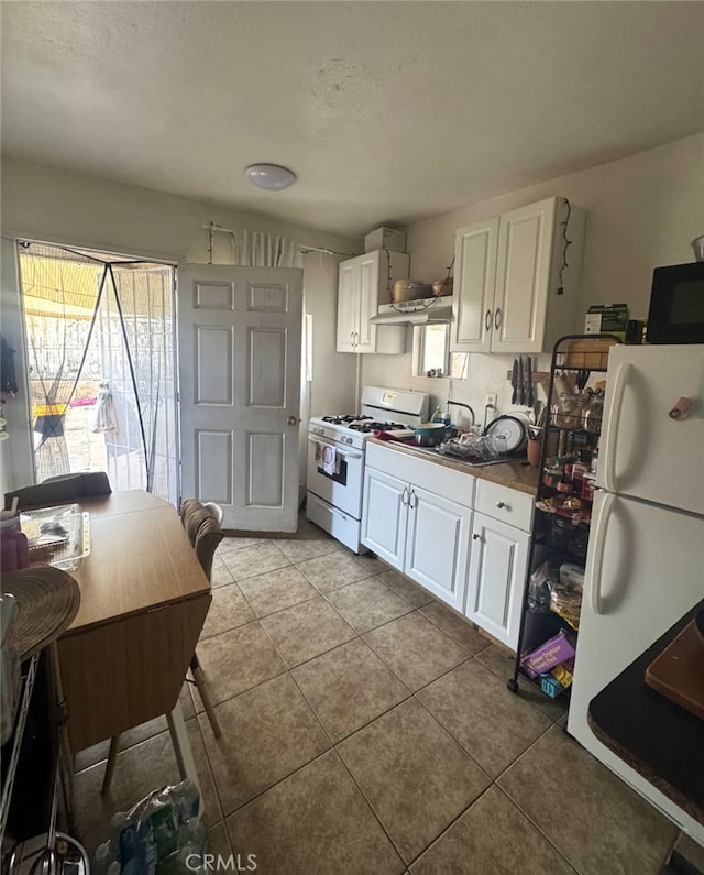 2043 City View Ave, Los Angeles, CA 90033 - kitchen with white appliances, tile patterned floors, white cabinets, and a sink