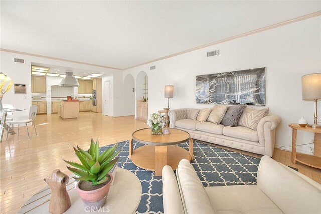 17527 Mondino Dr, Rowland Heights, CA 91748 - living area featuring light wood finished floors, ornamental molding, and arched walkways