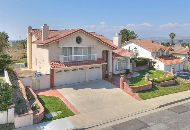 17527 Mondino Dr, Rowland Heights, CA 91748 - mediterranean / spanish house featuring a chimney, stucco siding, a tiled roof, and a garage