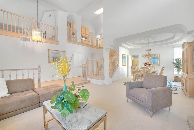 17527 Mondino Dr, Rowland Heights, CA 91748 - living area featuring a chandelier, stairs, carpet, a high ceiling, and a tray ceiling