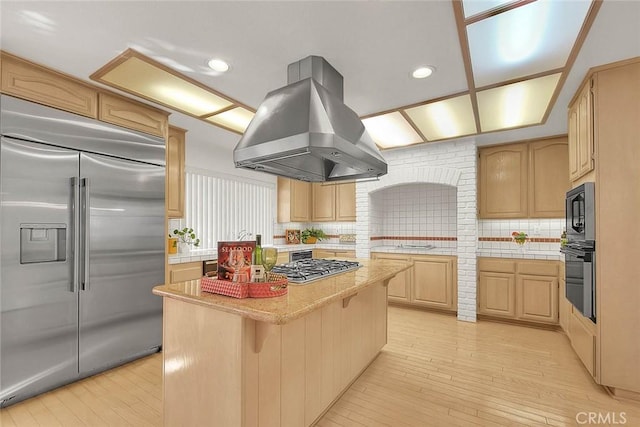 17527 Mondino Dr, Rowland Heights, CA 91748 - kitchen featuring black appliances, island range hood, a kitchen island, light wood-style flooring, and backsplash