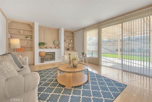 17527 Mondino Dr, Rowland Heights, CA 91748 - living area with built in shelves, wood finished floors, a fireplace, and crown molding