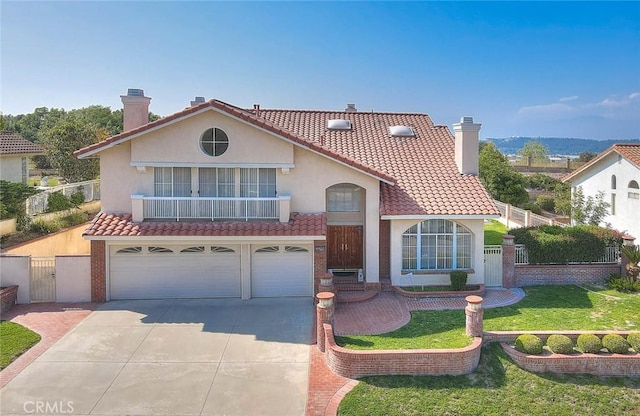 17527 Mondino Dr, Rowland Heights, CA 91748 - mediterranean / spanish-style home featuring a chimney, concrete driveway, a gate, and stucco siding