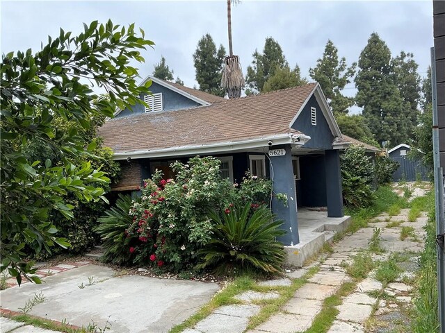 5621 La Mirada Ave, Los Angeles, CA 90038 - view of front facade with a shingled roof and stucco siding
