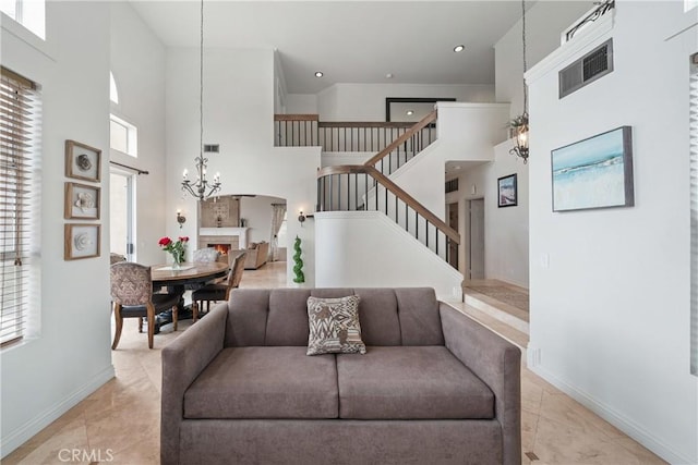 1081 Vista Lomas Ln, Corona, CA 92882 - living area featuring stairs, a towering ceiling, visible vents, an inviting chandelier, and baseboards