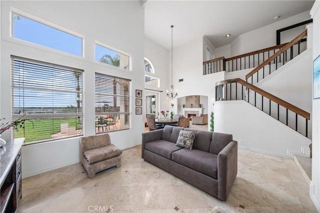 1081 Vista Lomas Ln, Corona, CA 92882 - living room featuring baseboards, stairs, a notable chandelier, and a high ceiling
