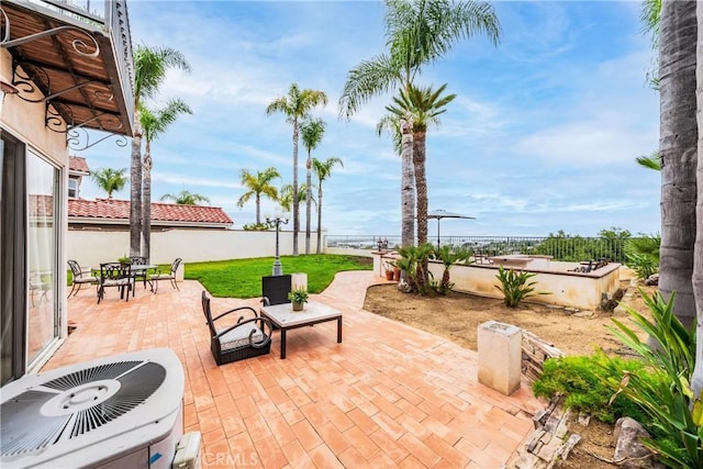 1081 Vista Lomas Ln, Corona, CA 92882 - view of patio featuring a fenced backyard and central AC