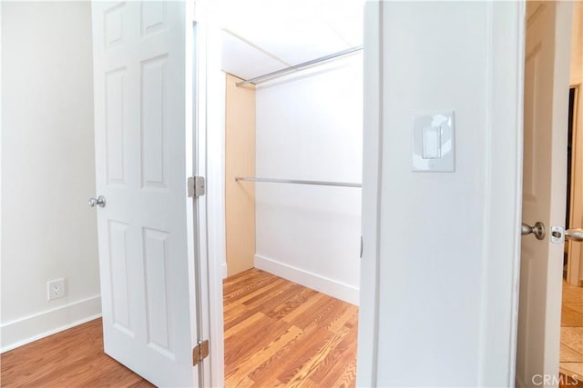 interior space featuring baseboards and wood finished floors
