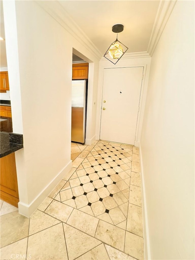 hallway featuring baseboards, ornamental molding, and light tile patterned floors