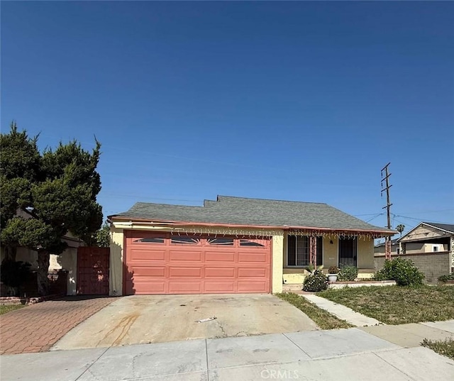 single story home featuring an attached garage, fence, and driveway