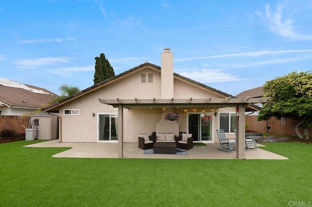 rear view of house featuring a fenced backyard, stucco siding, a shed, a lawn, and an outbuilding