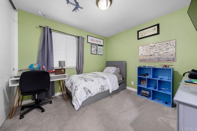 bedroom with carpet floors and baseboards