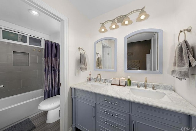 full bathroom featuring a sink, toilet, double vanity, and shower / tub combo with curtain