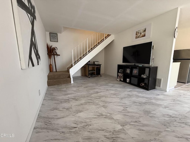 unfurnished living room featuring baseboards, visible vents, stairs, and marble finish floor