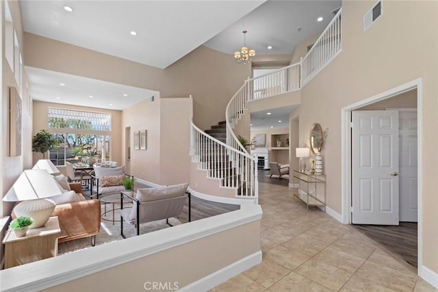 foyer entrance featuring stairway, baseboards, recessed lighting, and visible vents
