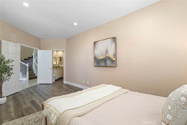 bedroom with connected bathroom, recessed lighting, baseboards, and wood finished floors