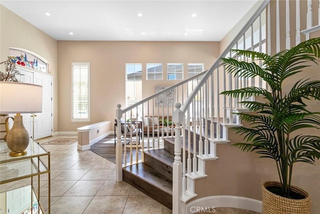 stairs featuring recessed lighting, baseboards, and tile patterned floors