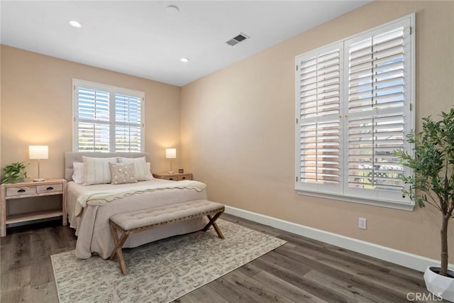 bedroom with visible vents, recessed lighting, baseboards, and wood finished floors